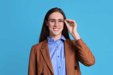 Photo of Portrait of banker in glasses on light blue background