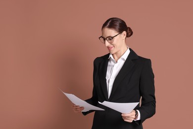 Photo of Portrait of banker with documents on brown background, space for text