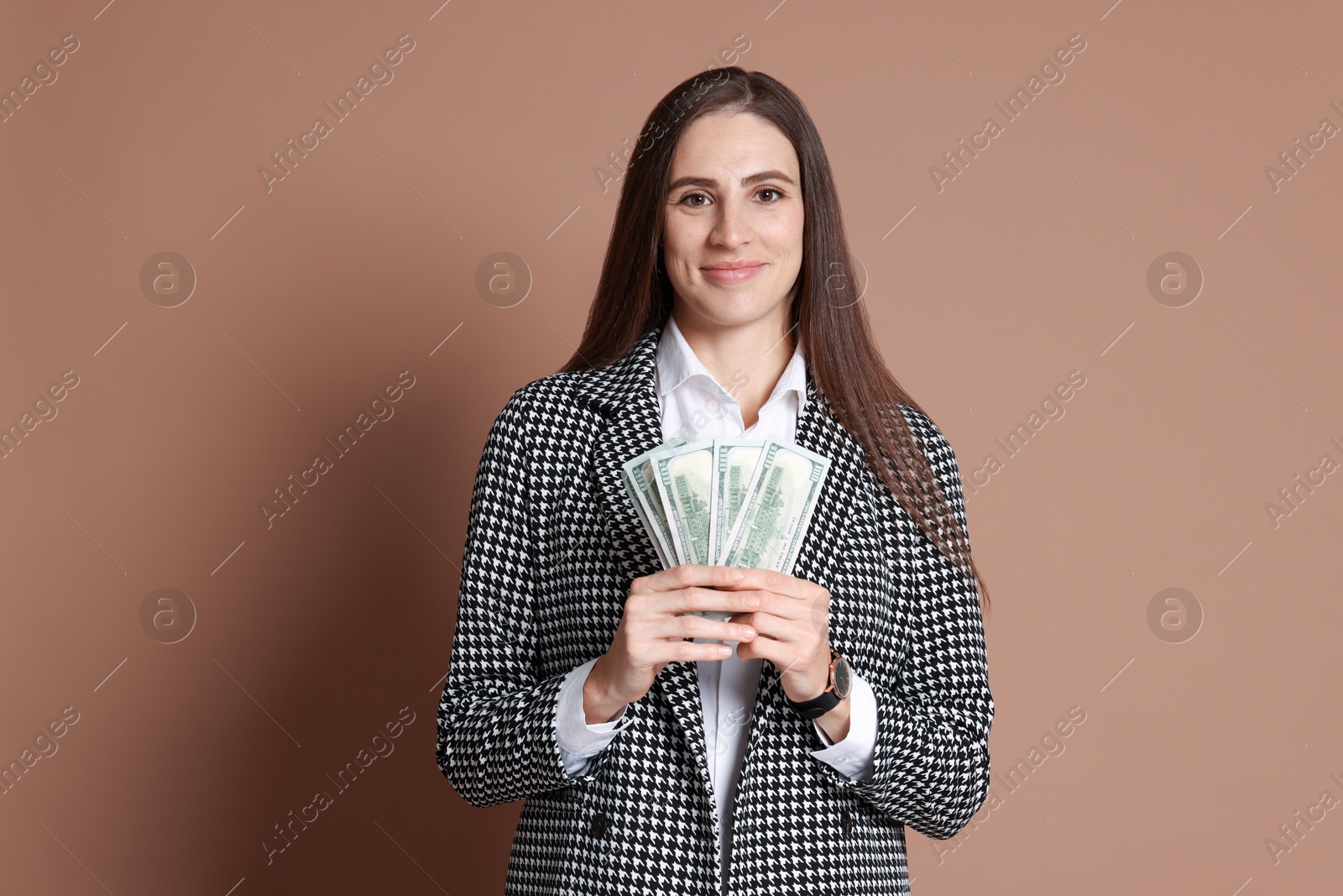 Photo of Banker with dollar banknotes on brown background