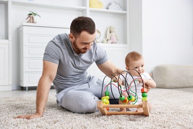 Photo of Dad playing with his cute baby at home