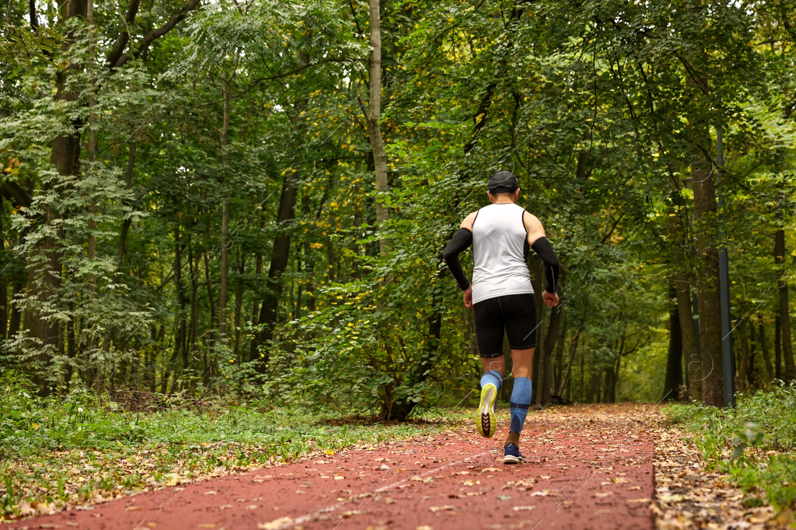 Photo of Athletic man running in park, space for text