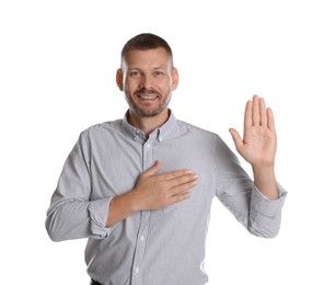 Man making promise with raised hand on white background. Oath gesture