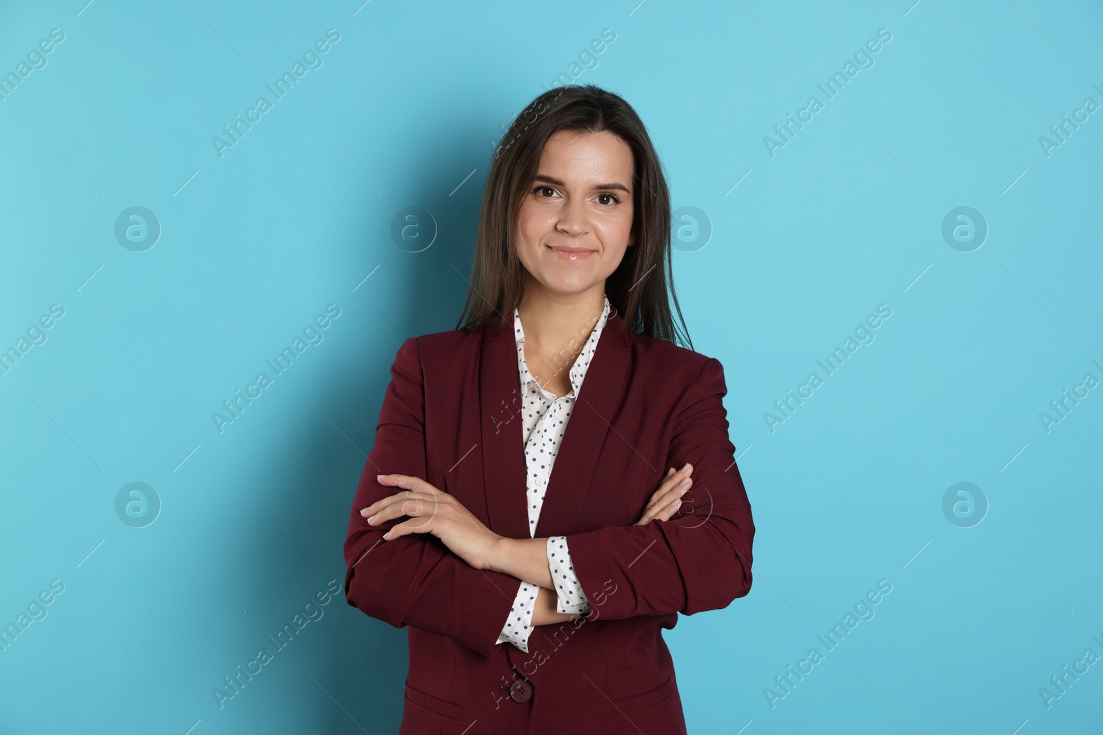 Photo of Banker with crossed arms on light blue background