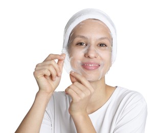 Photo of Teenage girl removing sheet facial mask on white background. Acne treatment