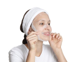 Photo of Teenage girl removing sheet facial mask on white background. Acne treatment