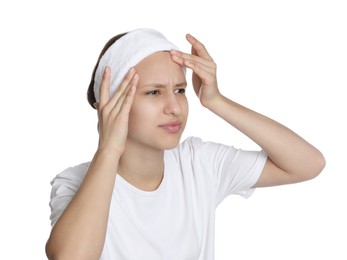 Photo of Upset teenage girl popping pimple on her face against white background. Acne problem