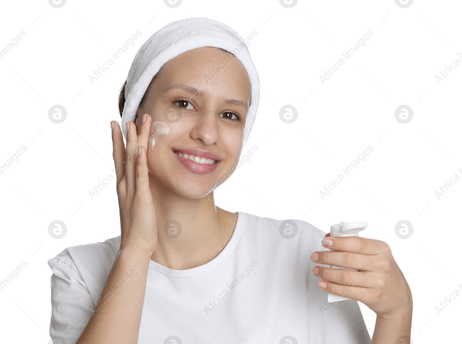 Photo of Teenage girl with acne problem applying cream on white background