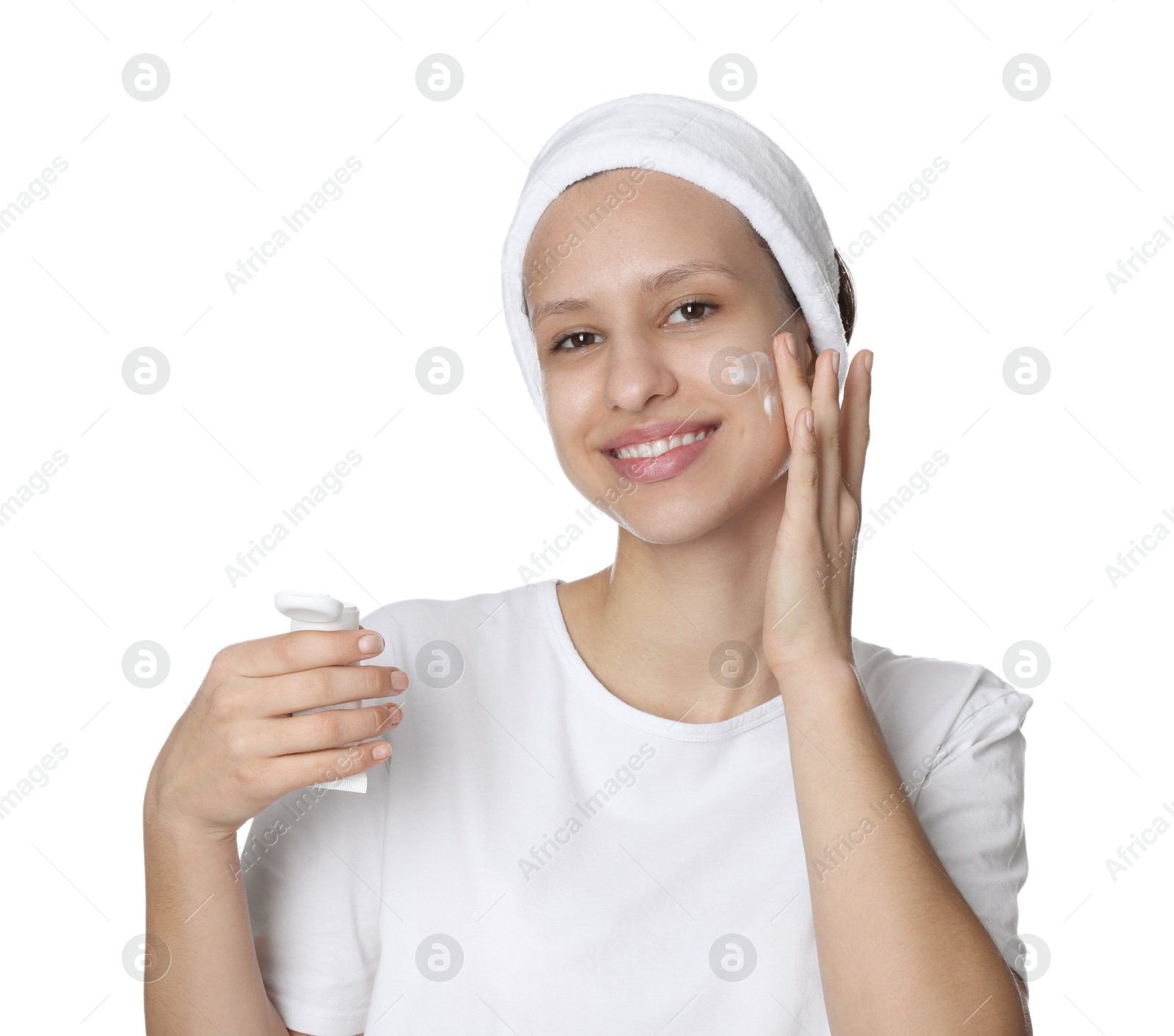 Photo of Teenage girl with acne problem applying cream on white background