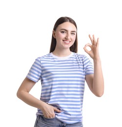 Happy young woman showing OK gesture on white background