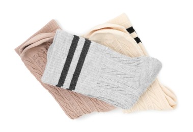 Photo of Different soft socks isolated on white, top view