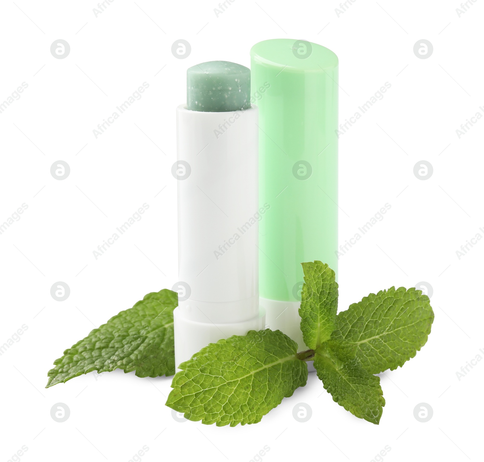 Photo of Mint lip balms and green leaves isolated on white. Cosmetic product