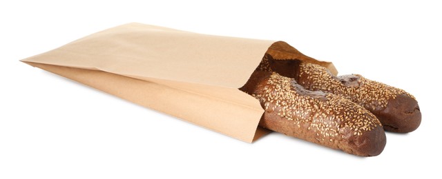 Photo of Fresh baguettes with sesame in paper bag isolated on white