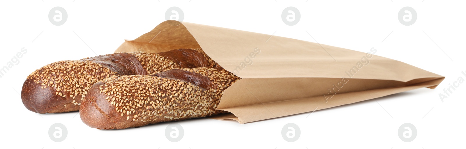 Photo of Fresh baguettes with sesame in paper bag isolated on white