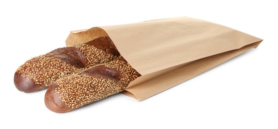 Photo of Fresh baguettes with sesame in paper bag isolated on white