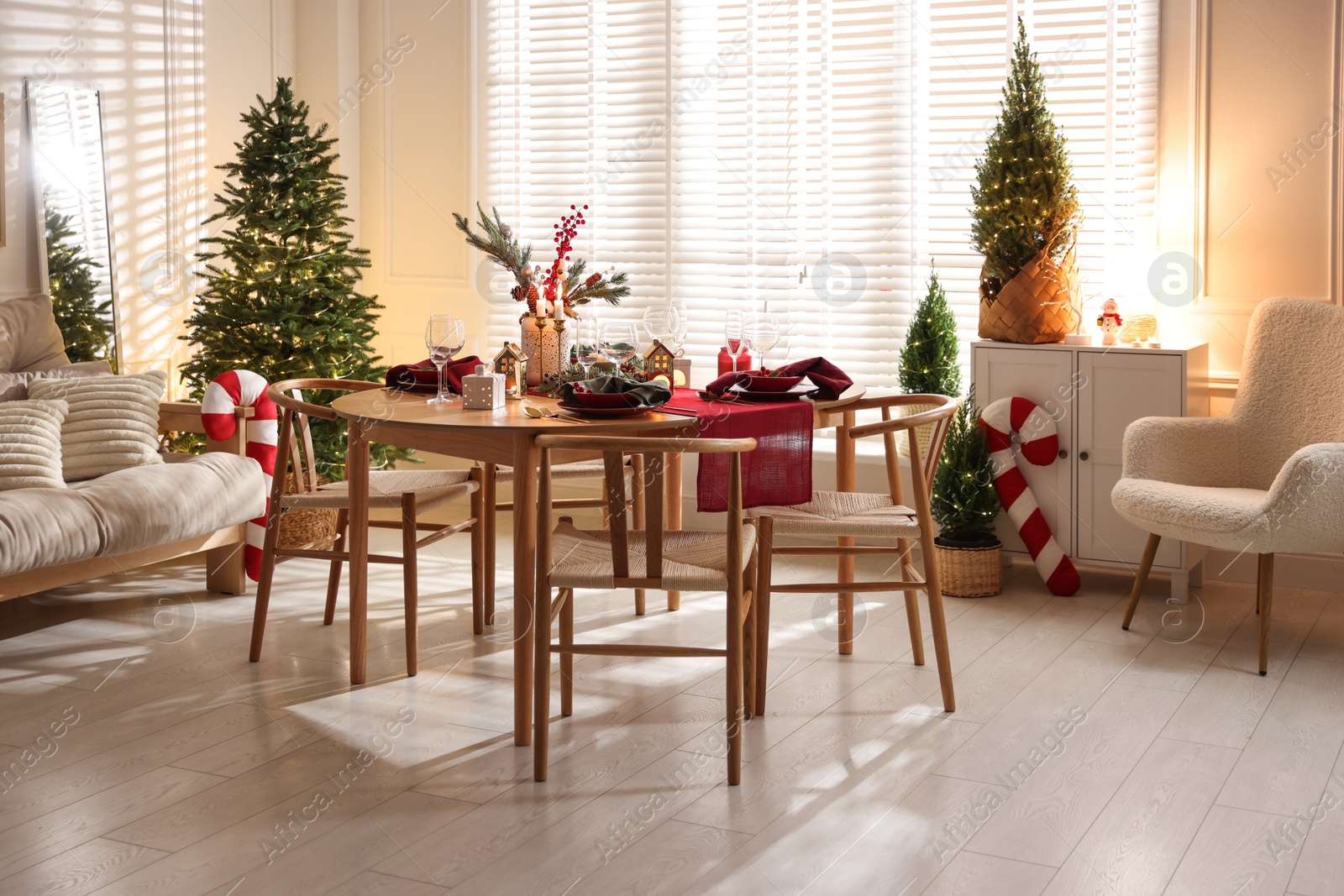 Photo of Christmas table setting with stylish dishware and festive decor indoors