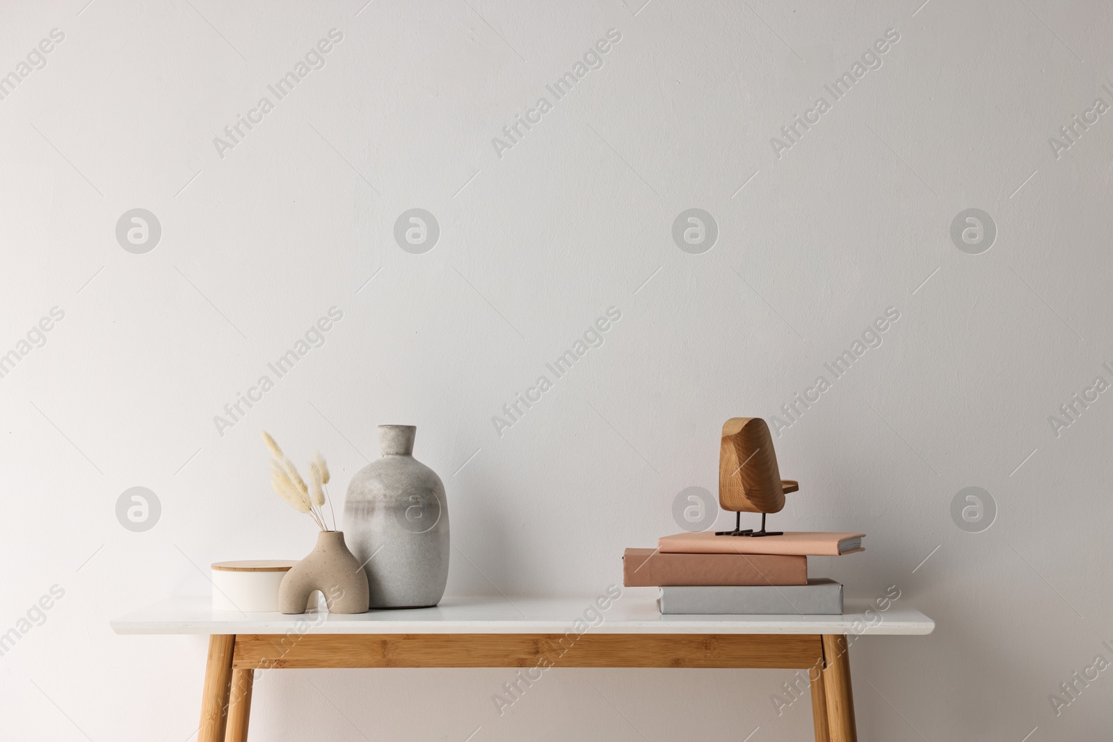 Photo of Stylish console table with decor near white wall indoors. Space for text