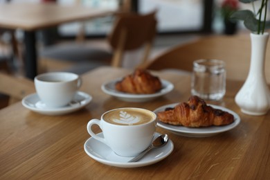 Photo of Delicious breakfast served on wooden table in cafe