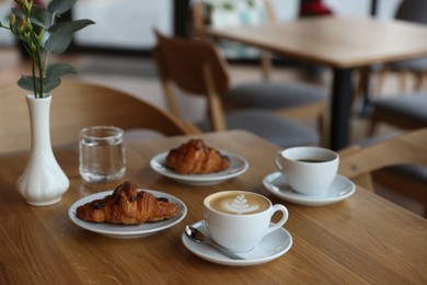 Photo of Delicious breakfast served on wooden table in cafe