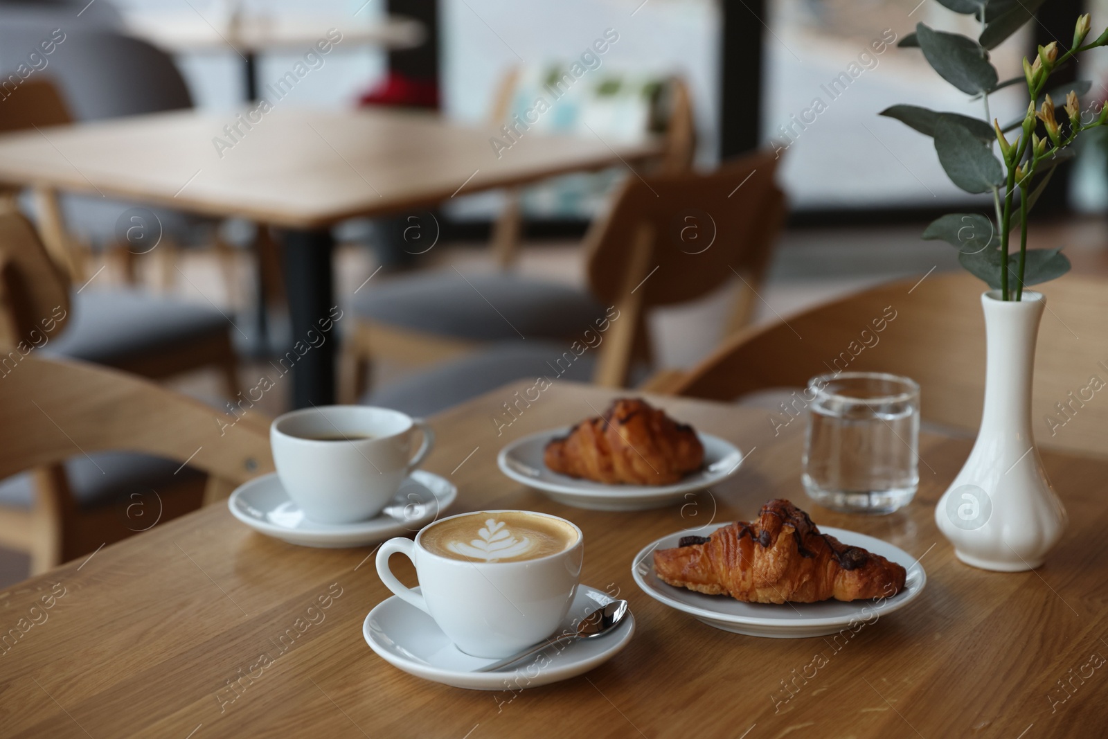 Photo of Delicious breakfast served on wooden table in cafe