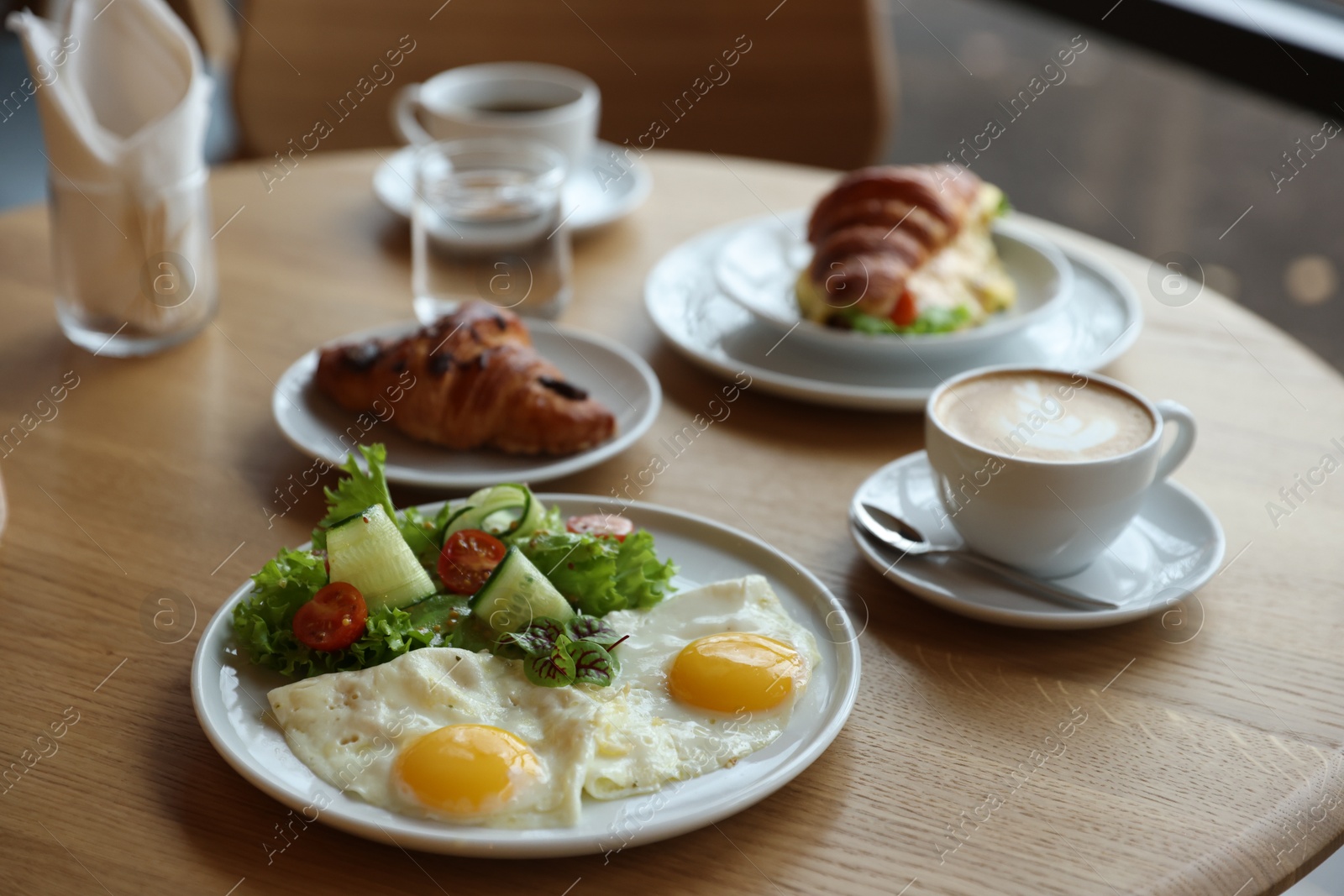 Photo of Delicious breakfast served on wooden table in cafe