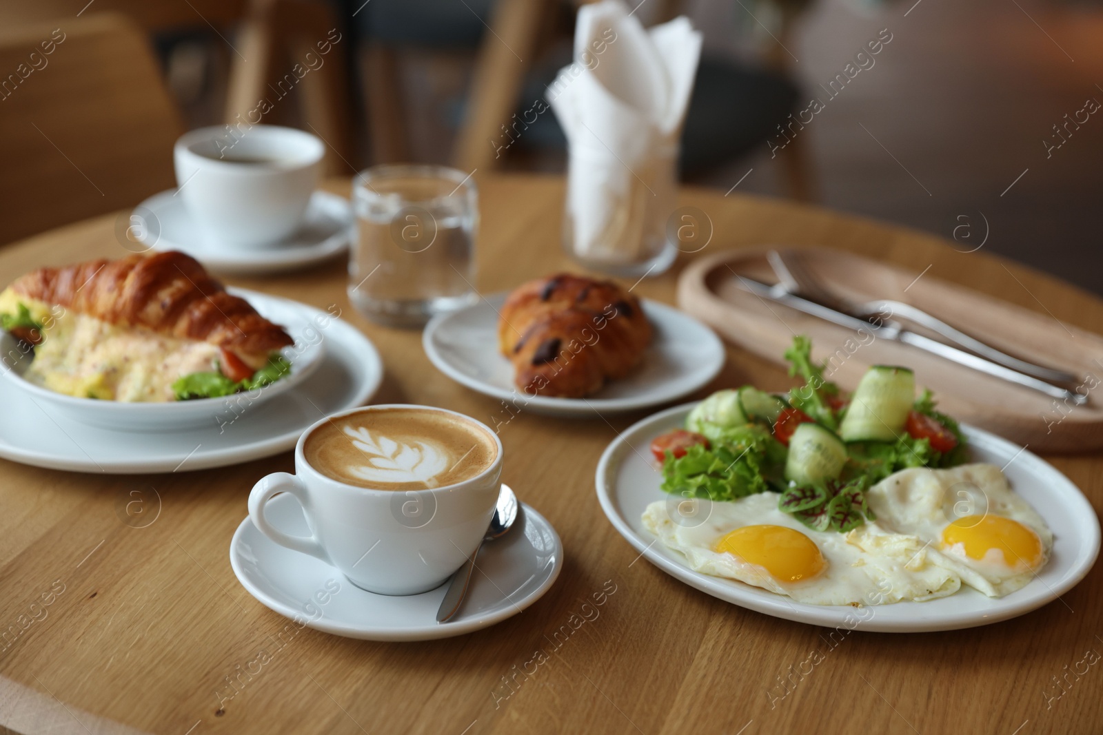 Photo of Delicious breakfast served on wooden table in cafe