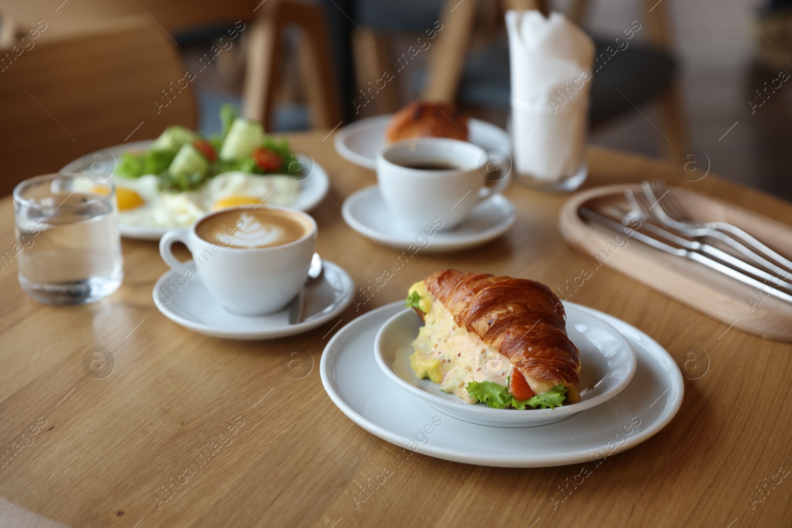 Photo of Delicious breakfast served on wooden table in cafe