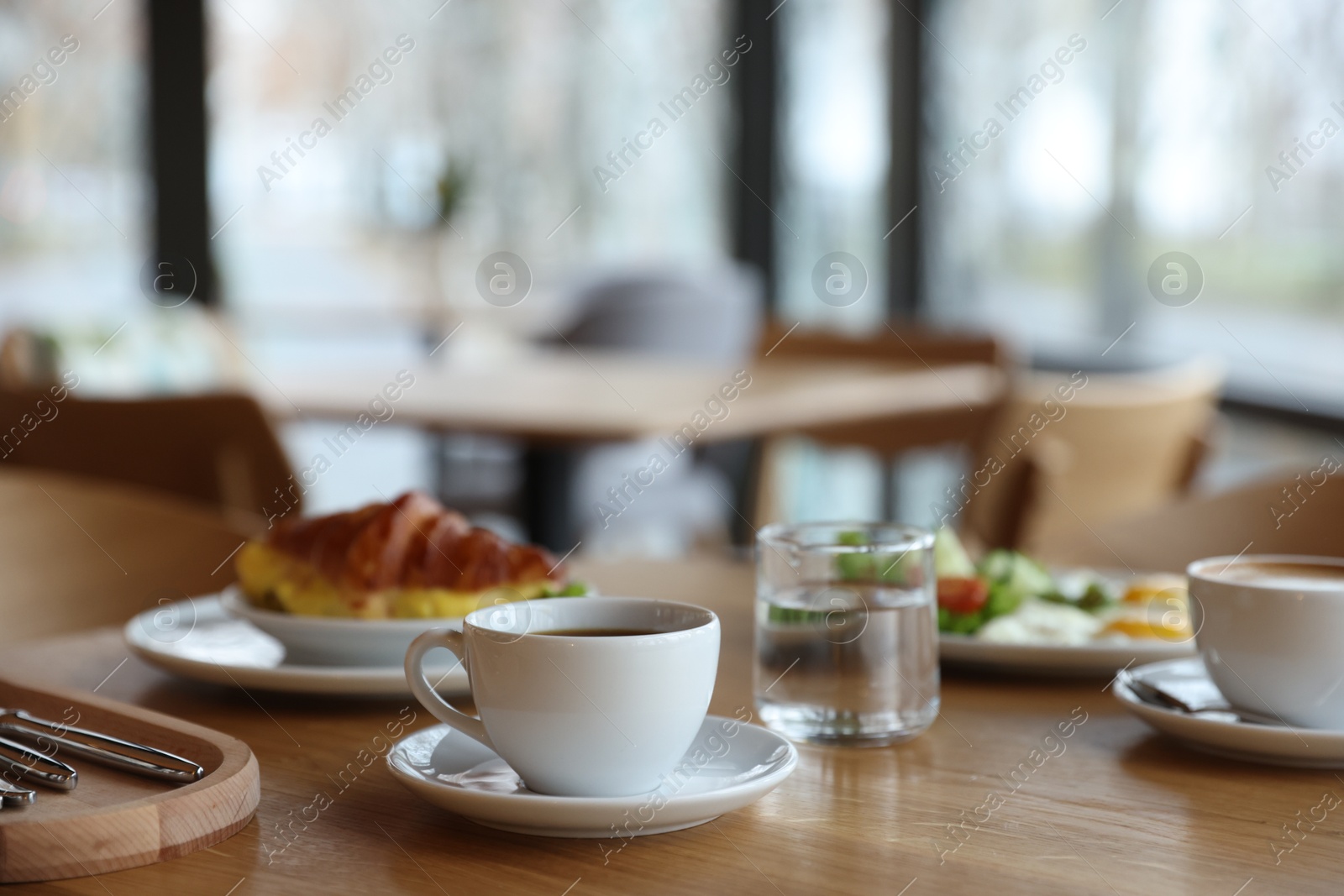 Photo of Delicious breakfast served on wooden table in cafe