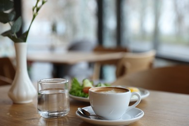 Photo of Delicious breakfast served on wooden table in cafe