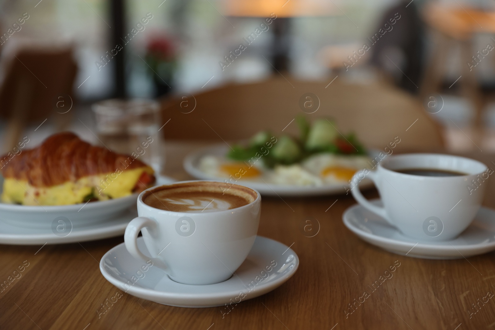 Photo of Delicious breakfast served on wooden table in cafe