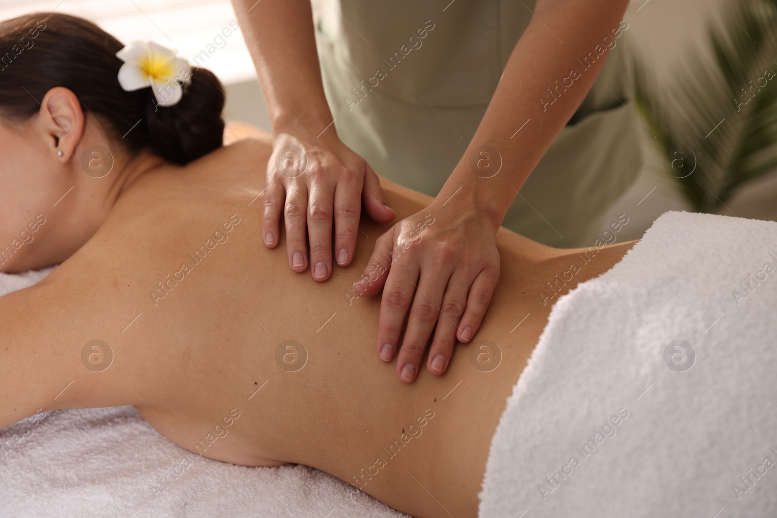 Photo of Woman receiving massage in spa salon, closeup