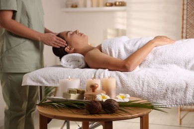 Photo of Woman receiving massage in salon, focus on spa supplies