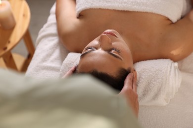 Photo of Woman receiving massage in spa salon, above view