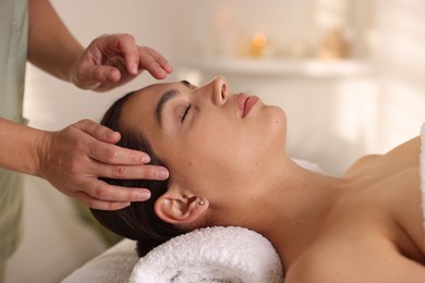 Photo of Woman receiving face massage in spa salon