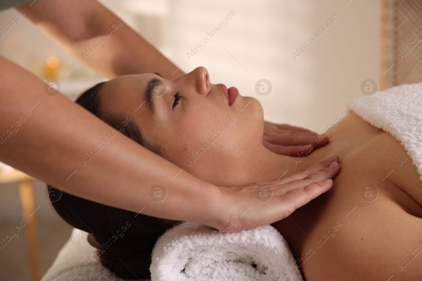 Photo of Young woman receiving massage in spa salon