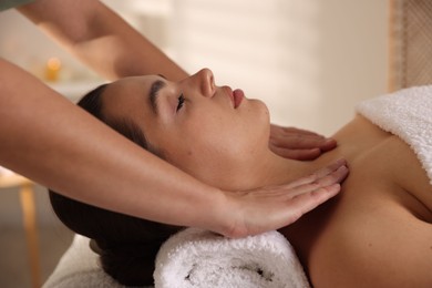 Photo of Young woman receiving massage in spa salon