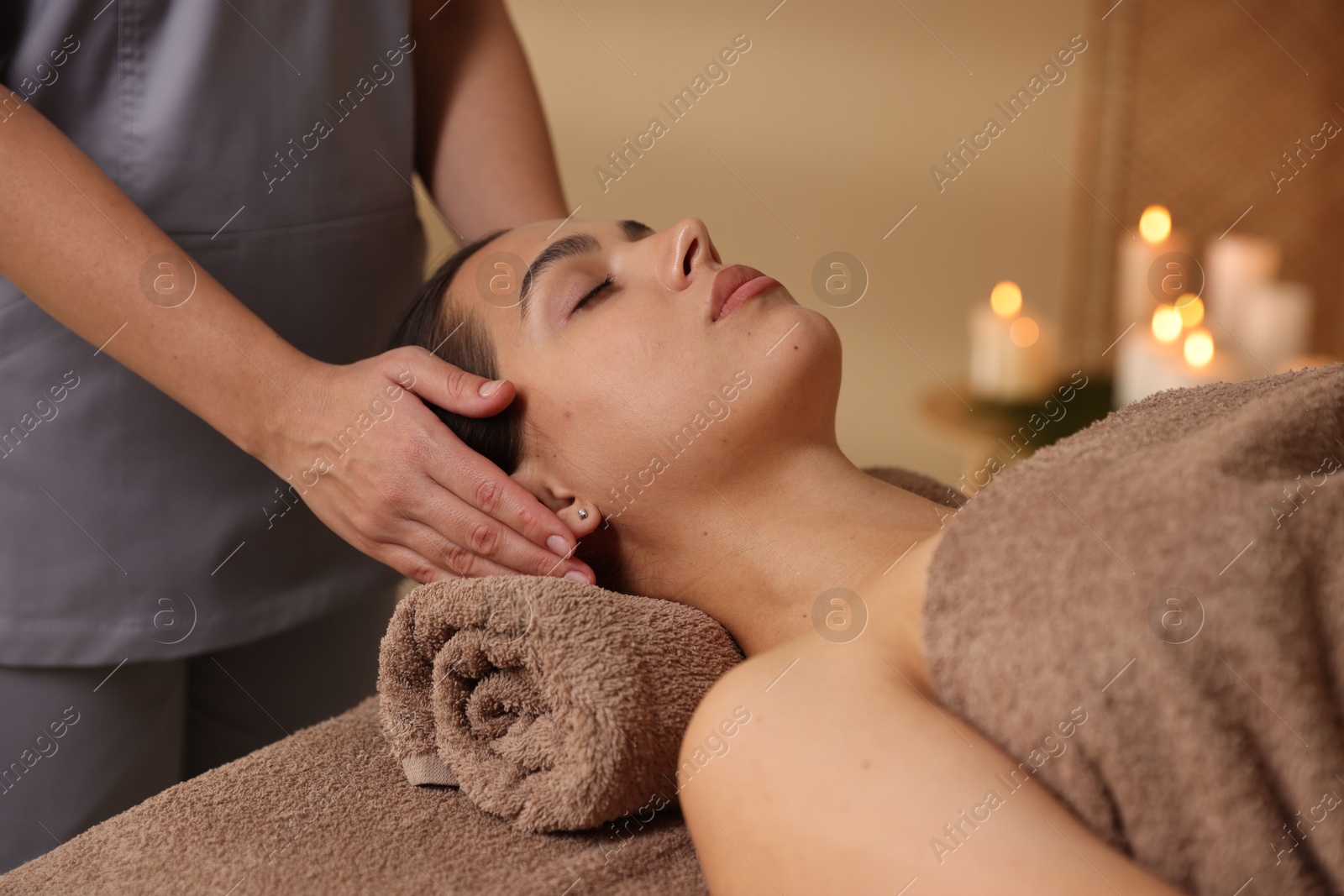 Photo of Young woman receiving massage in spa salon