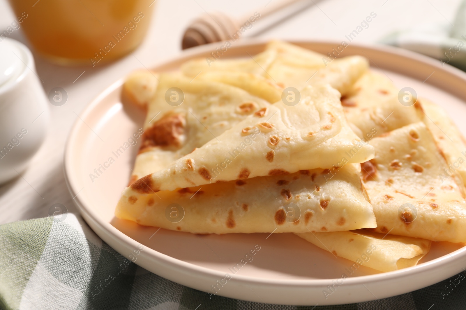 Photo of Delicious folded crepes on table, closeup view