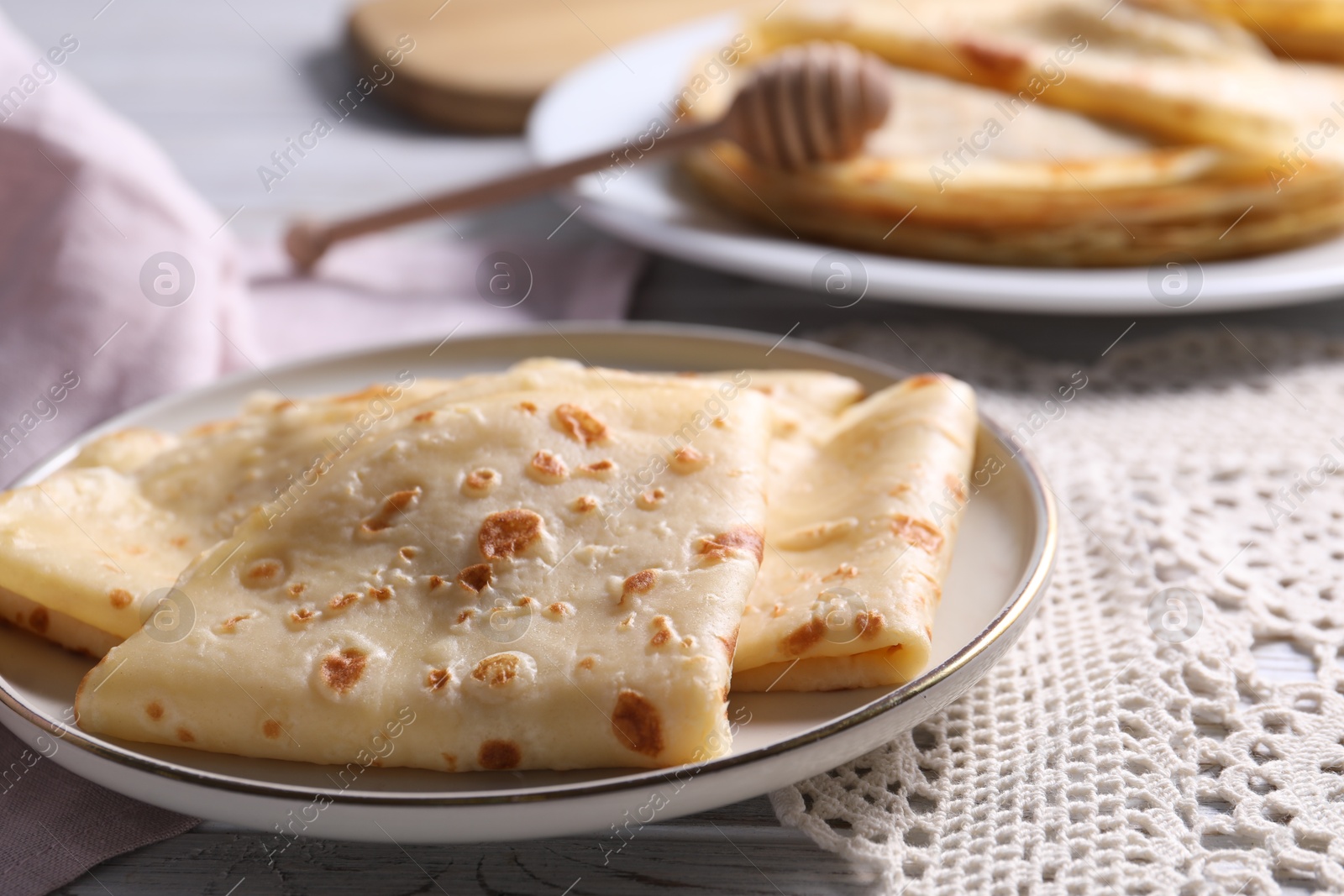 Photo of Delicious folded crepes on table, closeup view