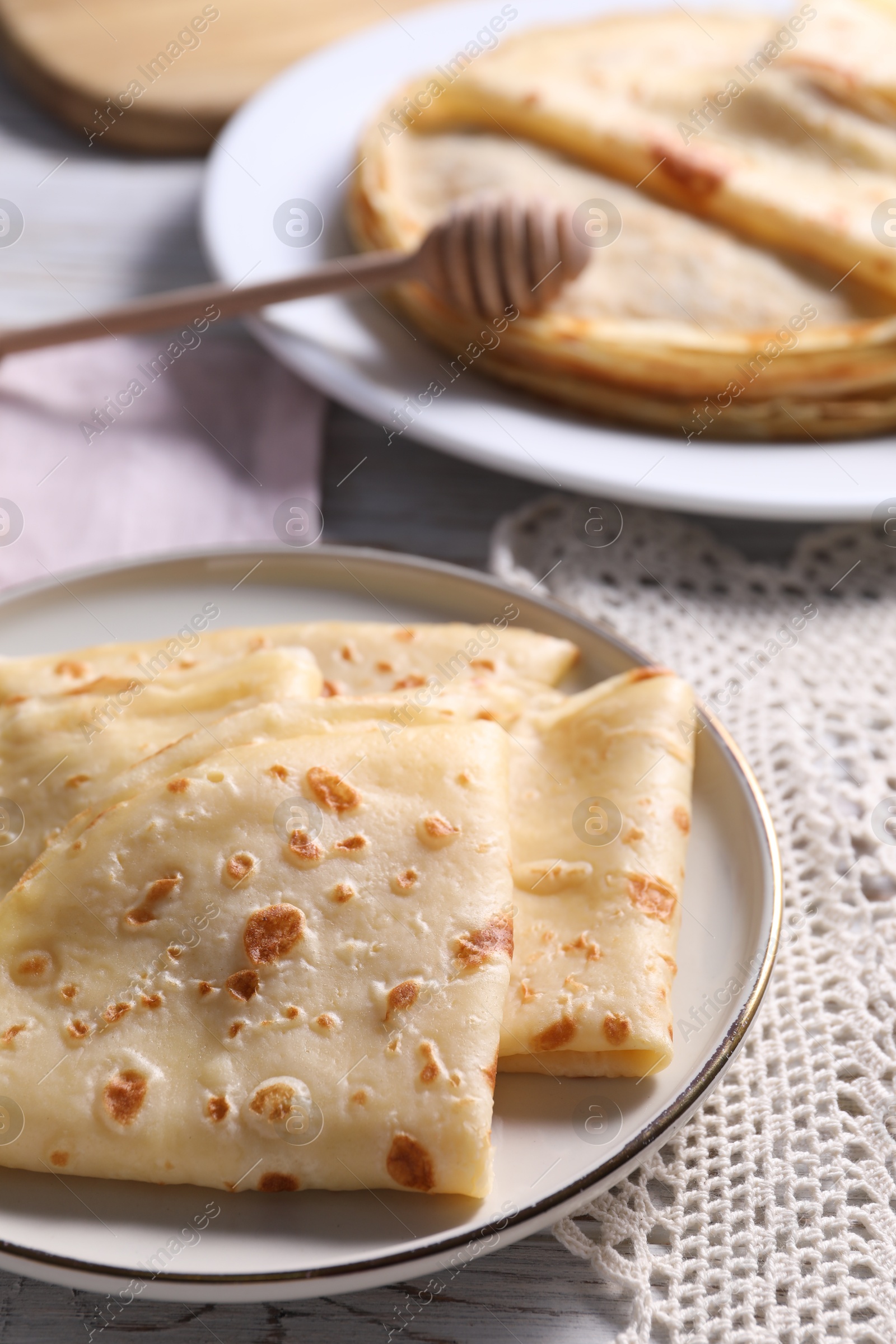 Photo of Delicious folded crepes on table, closeup view