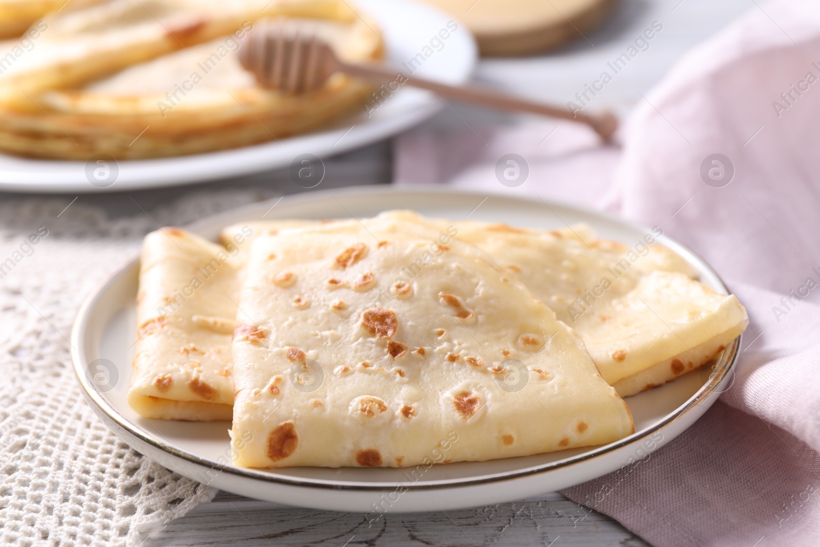 Photo of Delicious folded crepes on table, closeup view