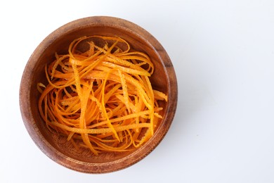 Photo of Fresh orange zest in bowl isolated on white, top view