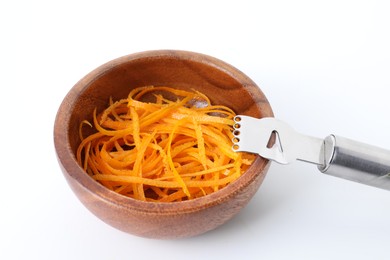 Photo of Fresh orange zest in bowl and zester tool isolated on white