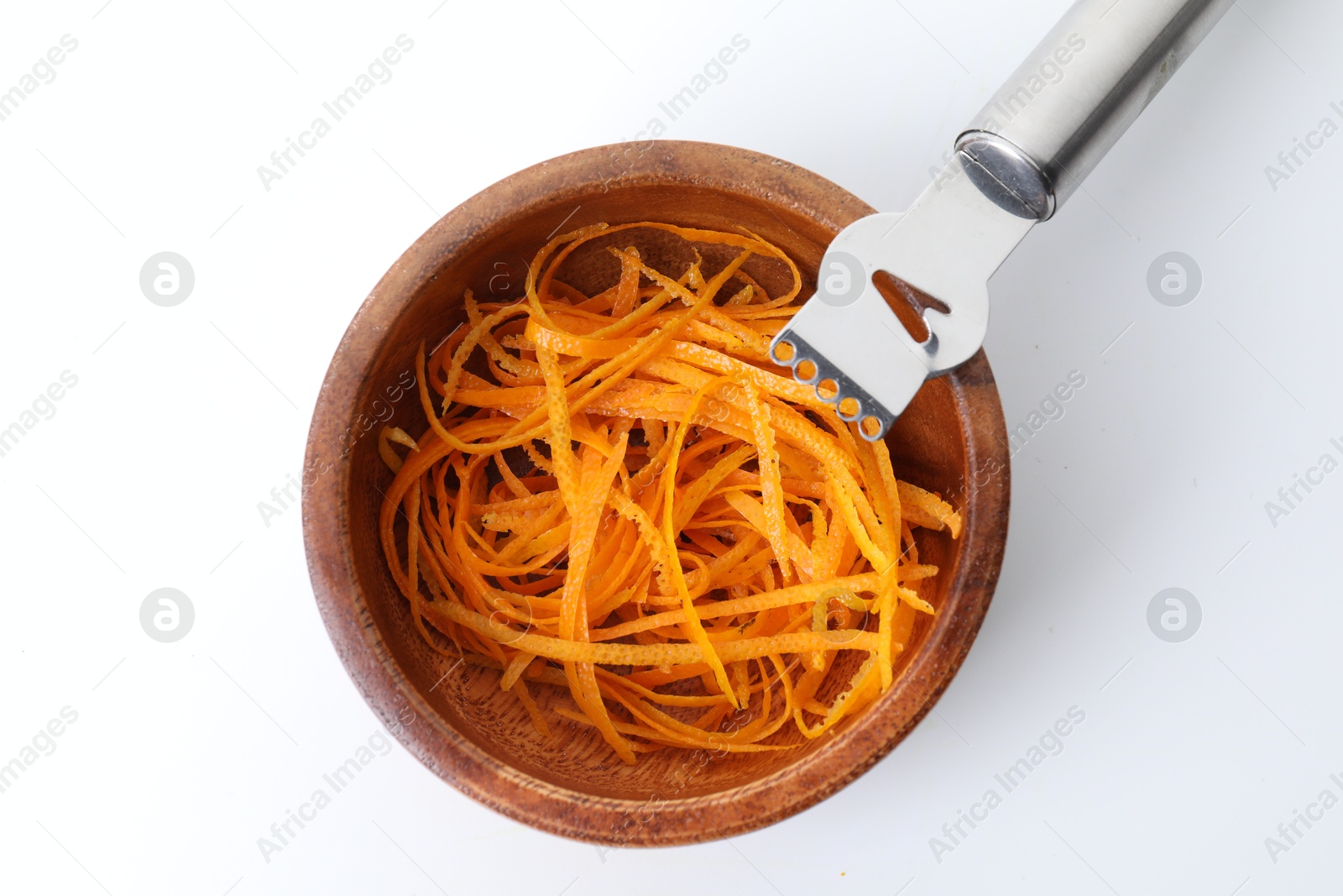 Photo of Fresh orange zest in bowl and zester tool isolated on white, top view