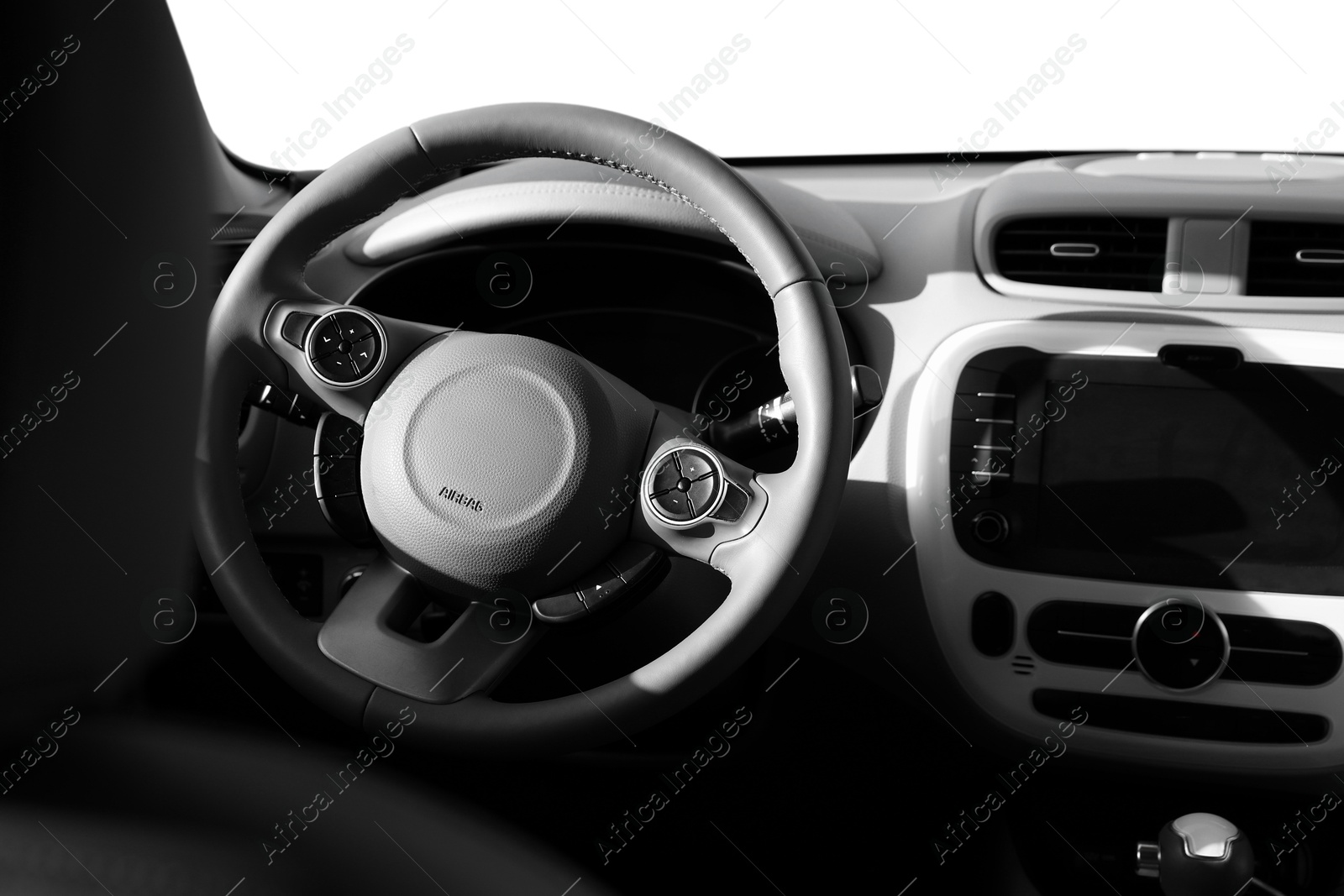 Image of Steering wheel and dashboard in modern car. White background