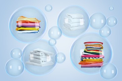 Image of Several soap bubbles with stacked laundry inside and empty ones floating on light blue background