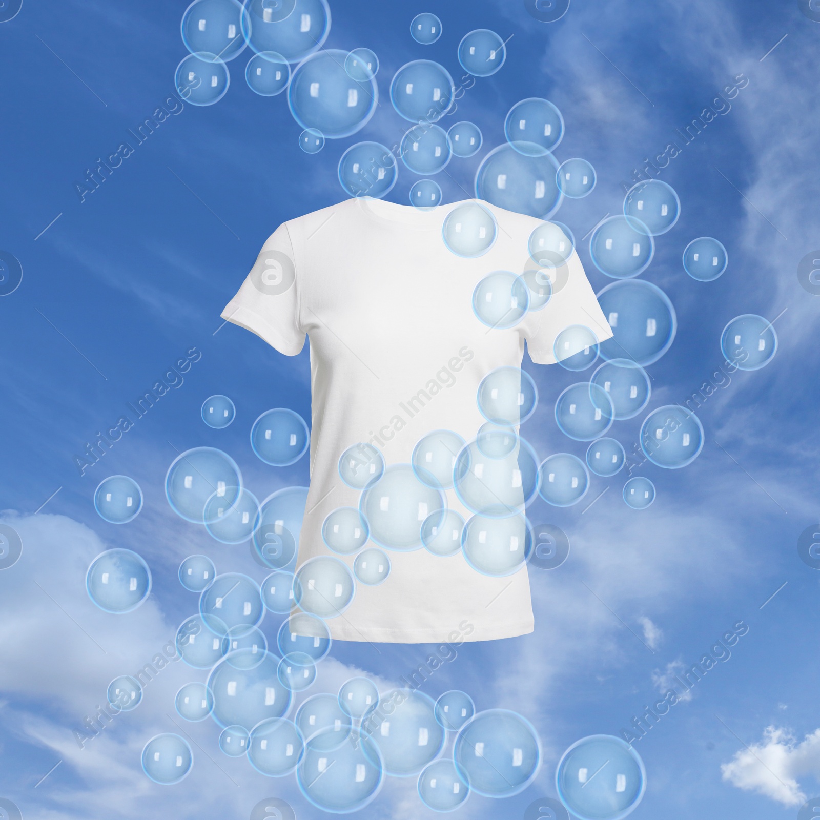 Image of T-shirt and floating soap bubbles in sky. Laundry day