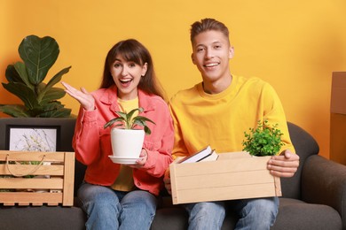 Happy couple with different stuff in new apartment. Housewarming party