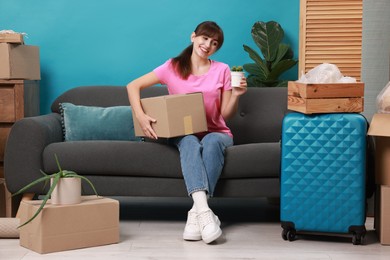 Photo of Happy woman with different stuff in new apartment. Housewarming party