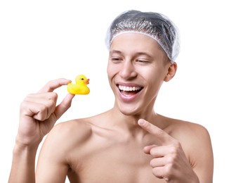 Photo of Happy man in shower cap with bath duck on white background