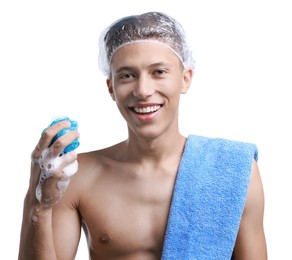 Photo of Happy man in shower cap with towel and mesh sponge on white background